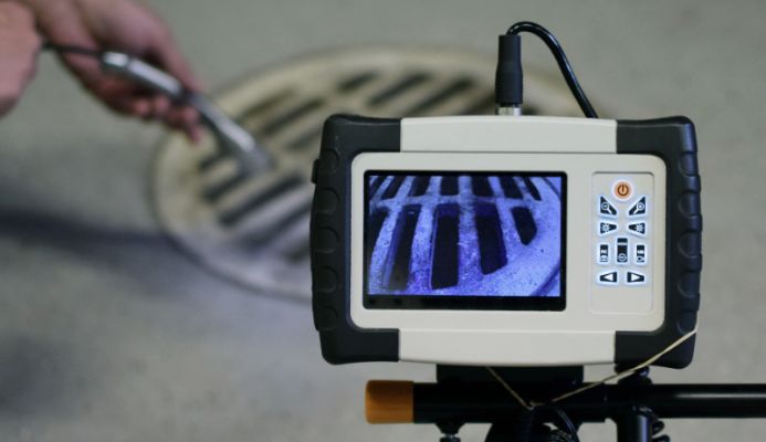 A close up of a CCTV drain monitor